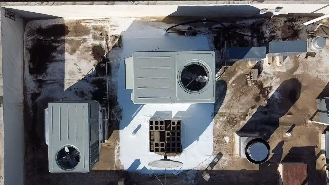 Commercial PVC roof restored with a reflective silicone roof coating in West Texas